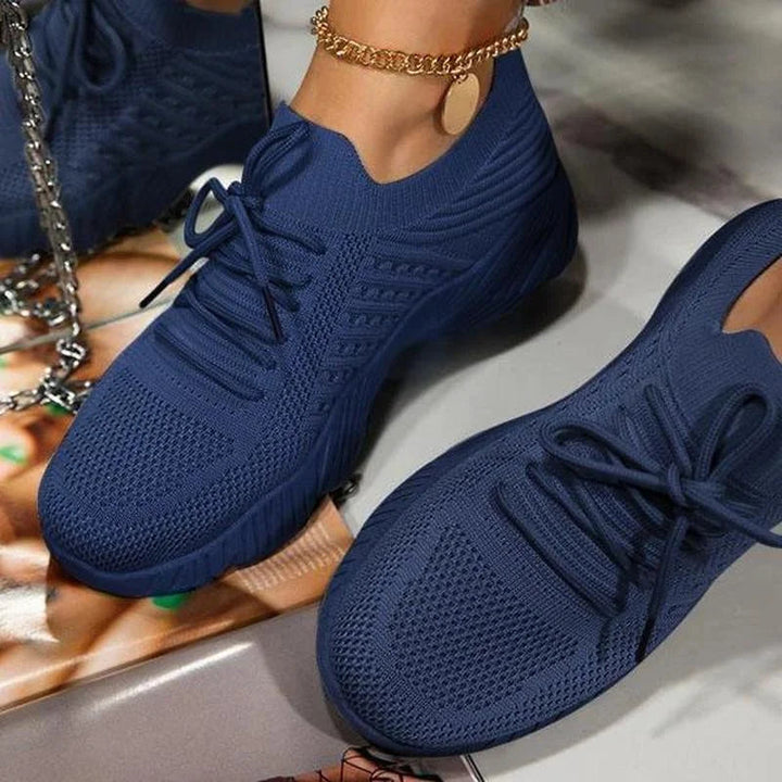 Versatile women's athletic sneakers, featuring breathable fabric & flexible sole.
