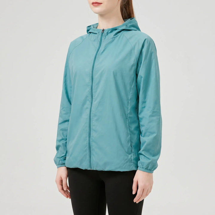 Versatile women's windbreaker, a lightweight hooded jacket for active spring/fall days.