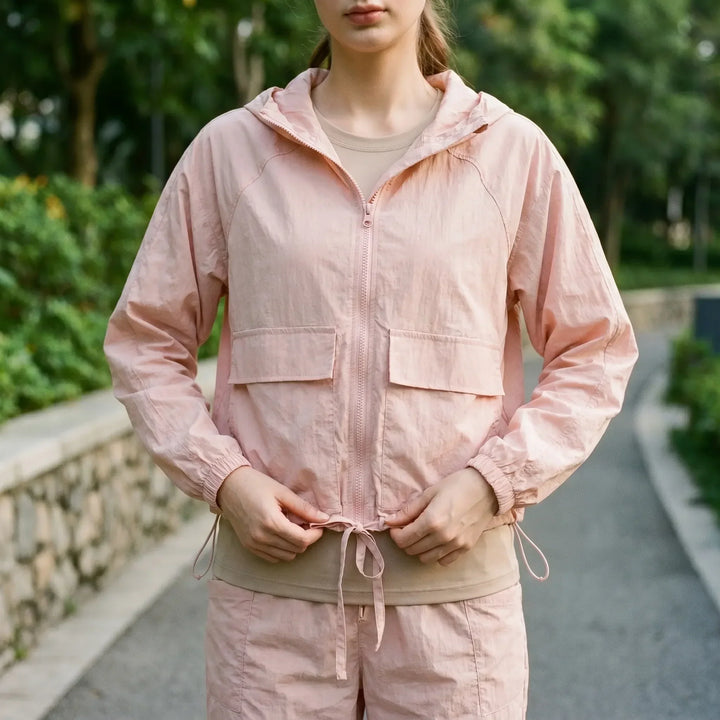 Women's lightweight hooded sports jacket for running & outdoor activities. Breathable activewear windbreaker.