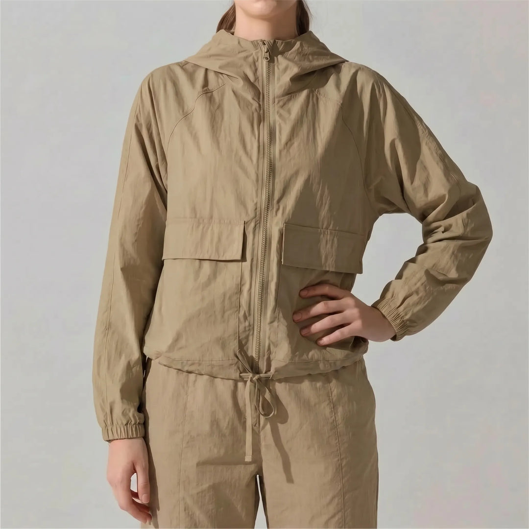 Compact, lightweight women's hooded jacket. Easy-pack activewear for travel, gym, spring/fall.