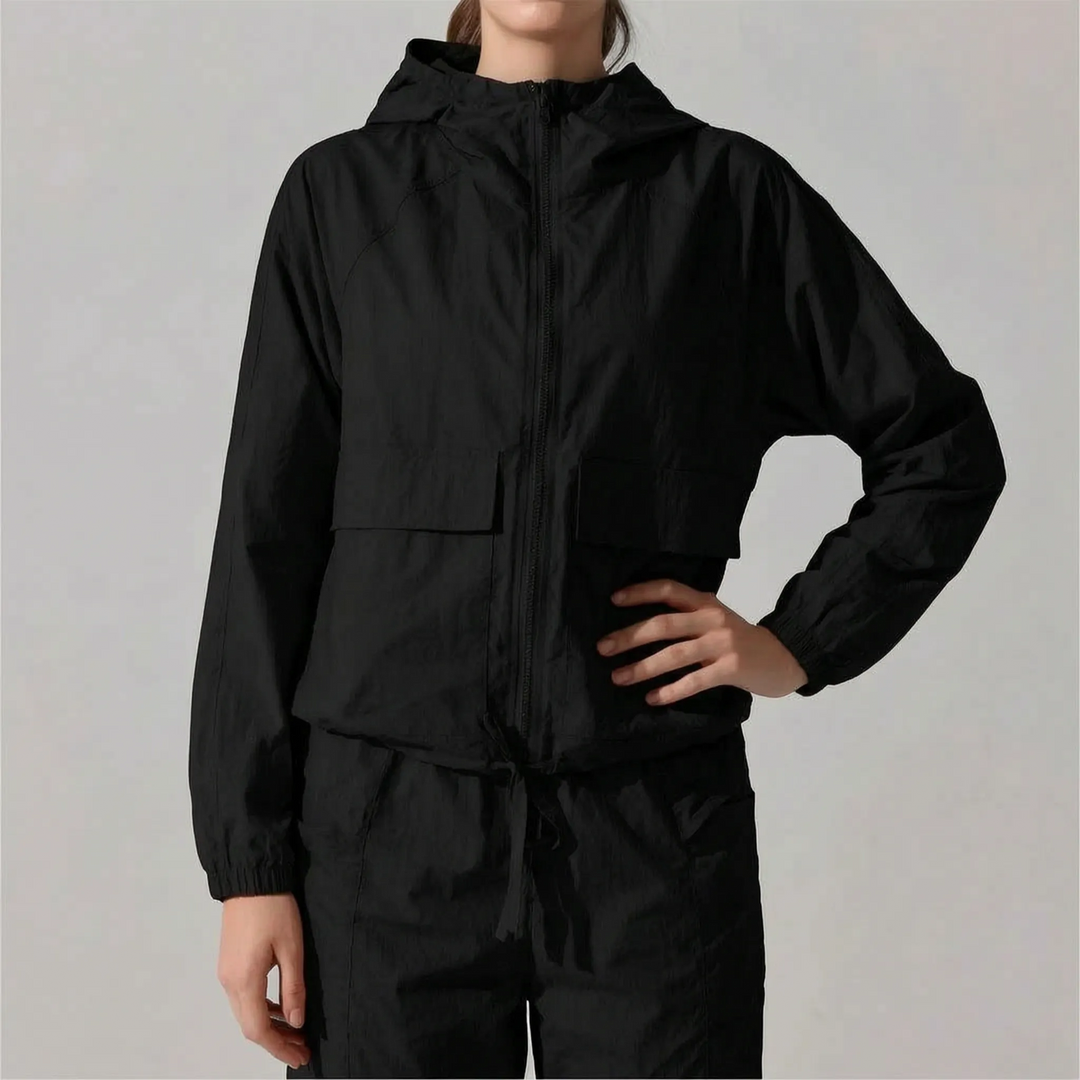 Adjustable hood on a women's lightweight activewear jacket, offering protection for running & sports.