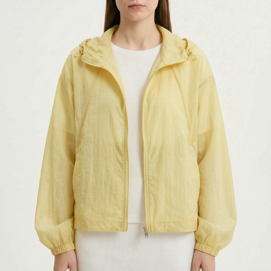 Women's lightweight hooded windbreaker featuring practical pockets and elastic cuffs for comfort.