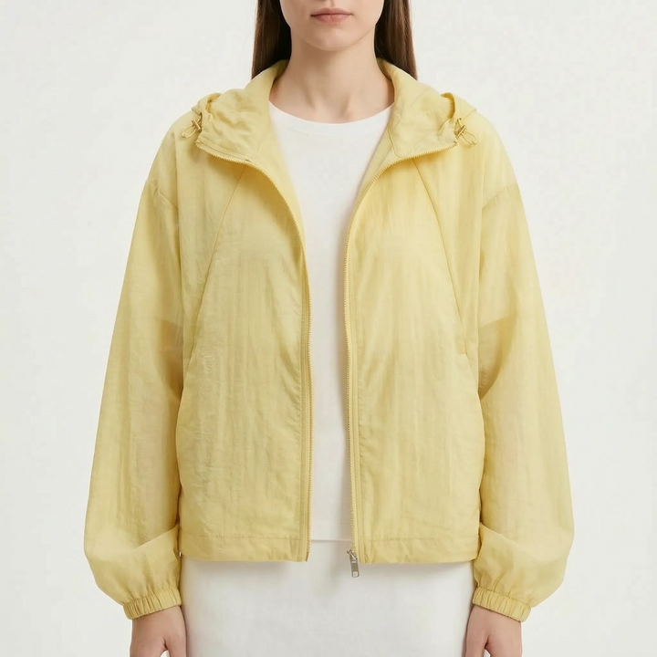 Women's lightweight hooded windbreaker featuring practical pockets and elastic cuffs for comfort.