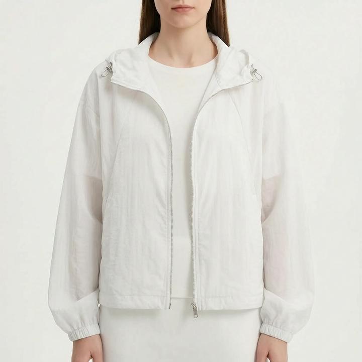 Protective women's lightweight hooded windbreaker jacket, ideal for shielding against wind and light rain.