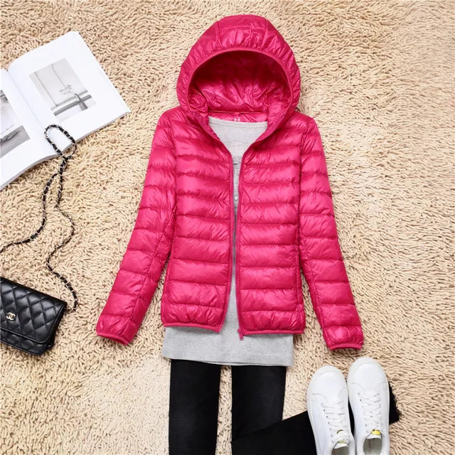 Women's lightweight packable puffer jacket with hood, ideal for travel and fall fashion.