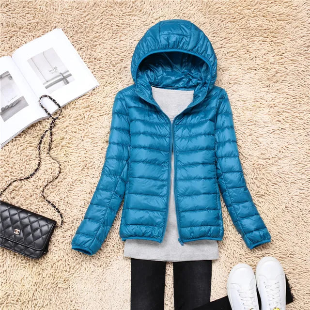 Sleek women's lightweight packable puffer jacket with hood, modern fall fashion outerwear.