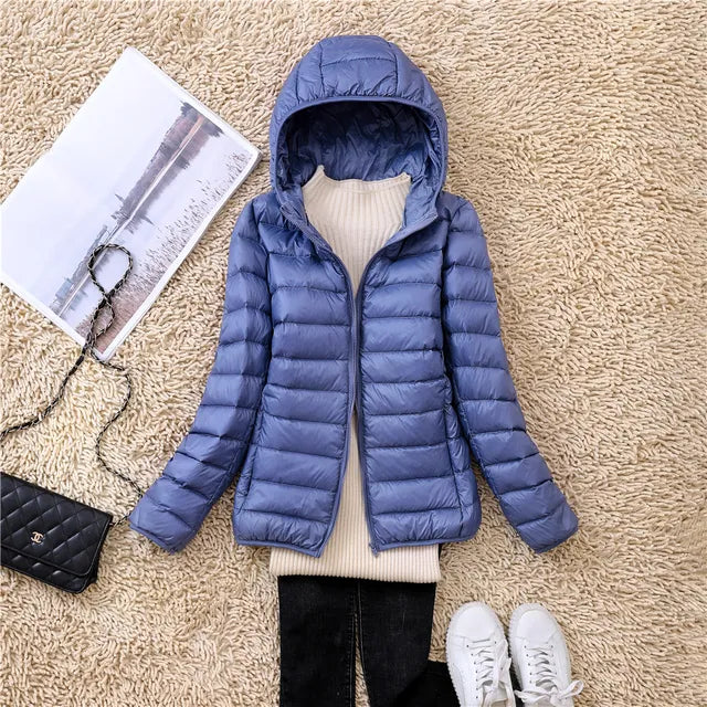 Versatile women's hooded puffer jacket, lightweight & packable for all seasons travel.