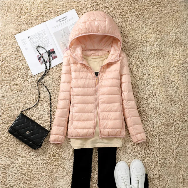 Woman hiking in lightweight packable puffer jacket, perfect warm winter coat for outdoors.