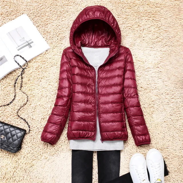 Side view of women's lightweight packable puffer jacket, showing hooded design and fit.