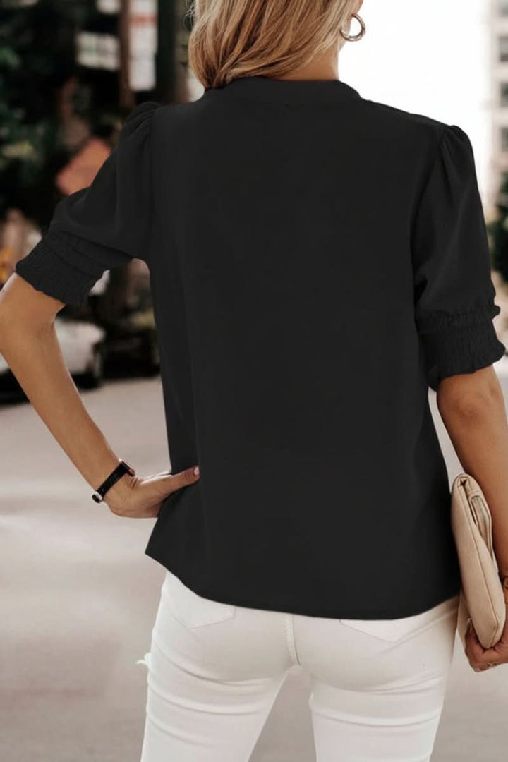Elegant V-neck blouse with puff sleeves, a versatile short sleeve top for office or casual wear.
