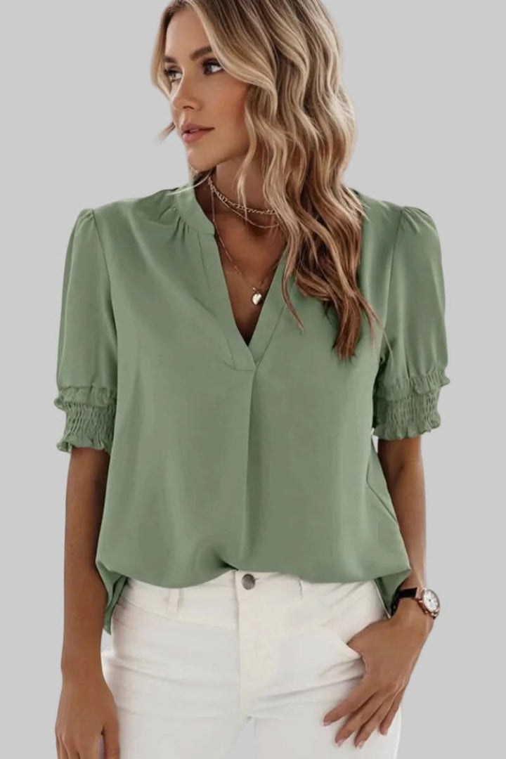 Women's fashionable V-neck puff sleeve blouse, a lightweight and loose fit top suitable for work or leisure.