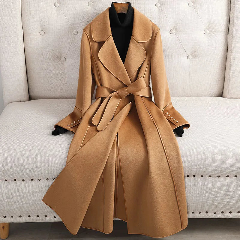Women's long belted trench coat, tailored for elegant and versatile style in classic design.