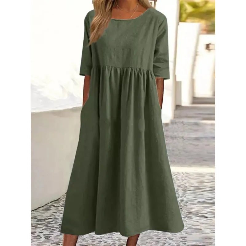 Women's long maxi dress with half-sleeves and practical pockets. Ideal for comfortable, casual summer wear.