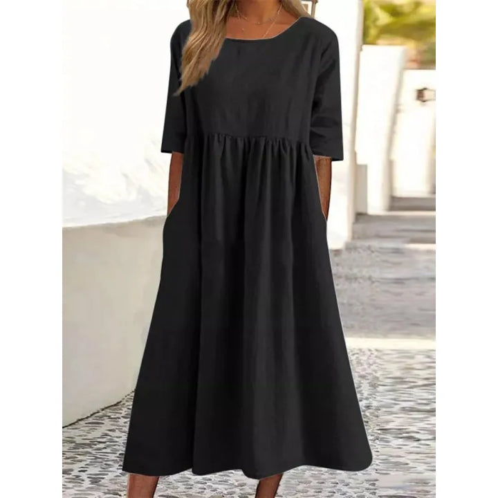 Flowy women's summer maxi dress with comfy half-sleeves and discreet side pockets. Relaxed, elegant style.