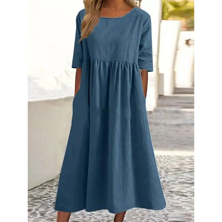 Modest women's casual maxi dress. Long design, comfortable fit, featuring half-sleeves and functional pockets.