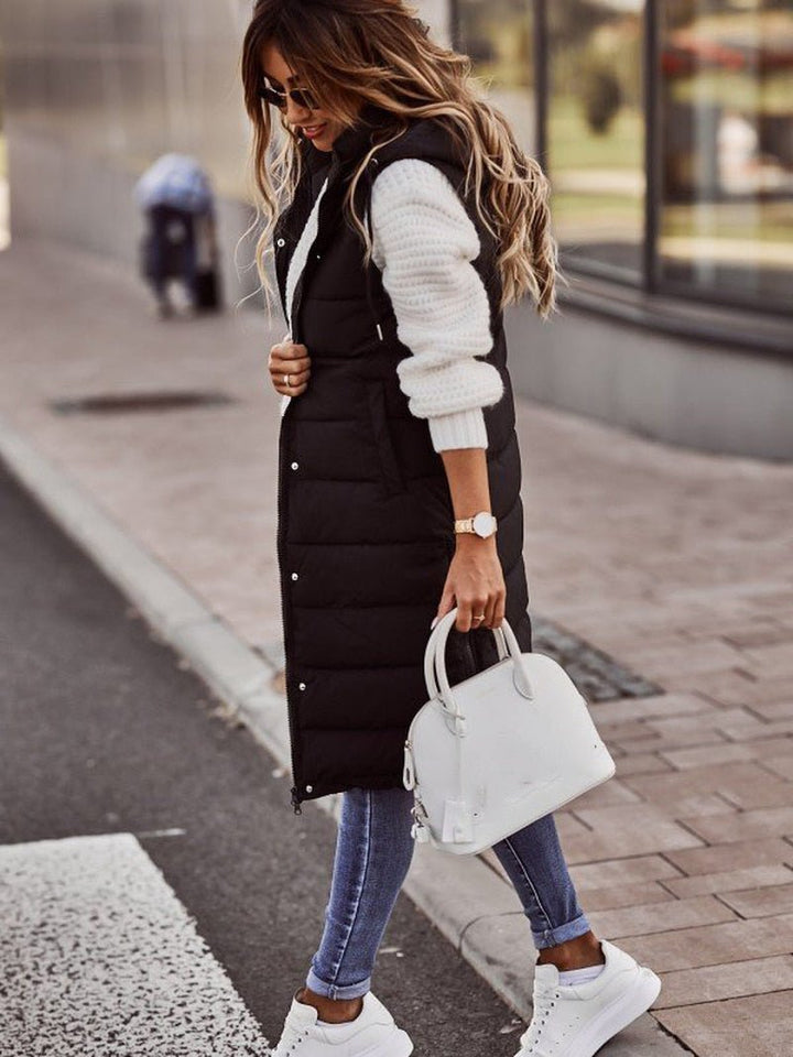 Women's long quilted bodywarmer vest for cozy fall and winter layering. Stylish sleeveless outerwear.