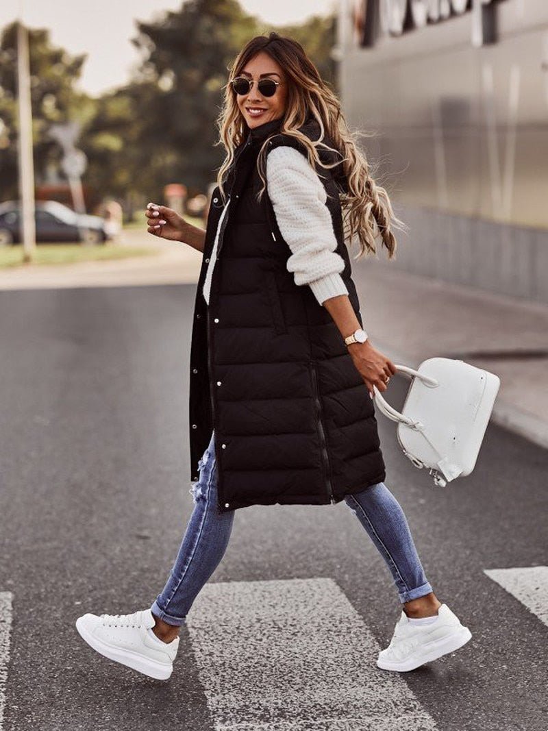 Elegant women's quilted long bodywarmer vest, a chic layering piece. Ideal outerwear for cool weather fashion.