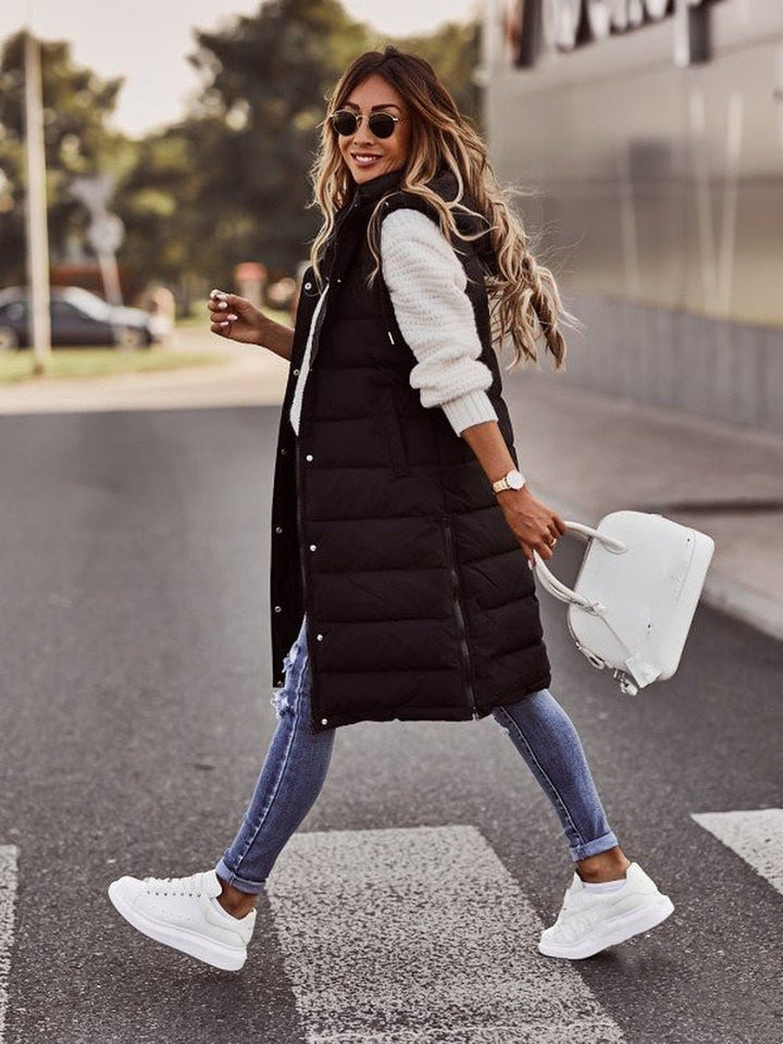 Elegant women's quilted long bodywarmer vest, a chic layering piece. Ideal outerwear for cool weather fashion.