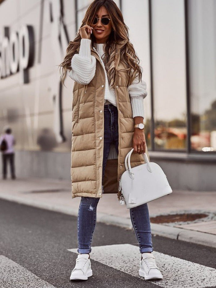 Comfortable women's long quilted vest, a practical sleeveless jacket. Essential casual outerwear for colder days.
