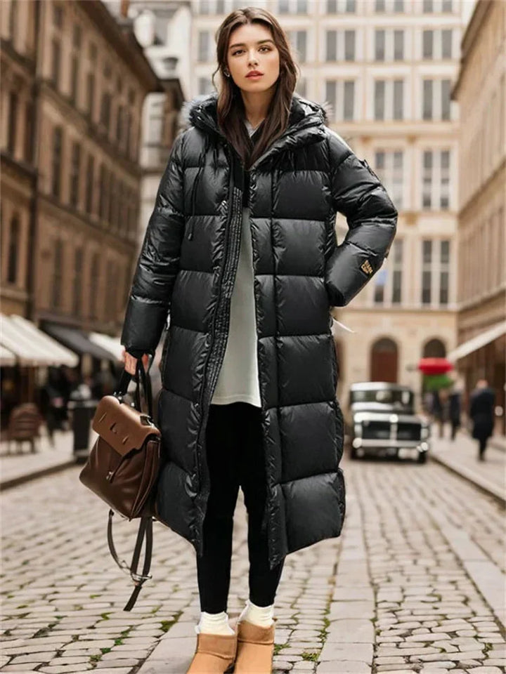 Elegant women's long quilted winter outerwear, featuring a cozy hood for supreme cold weather comfort.