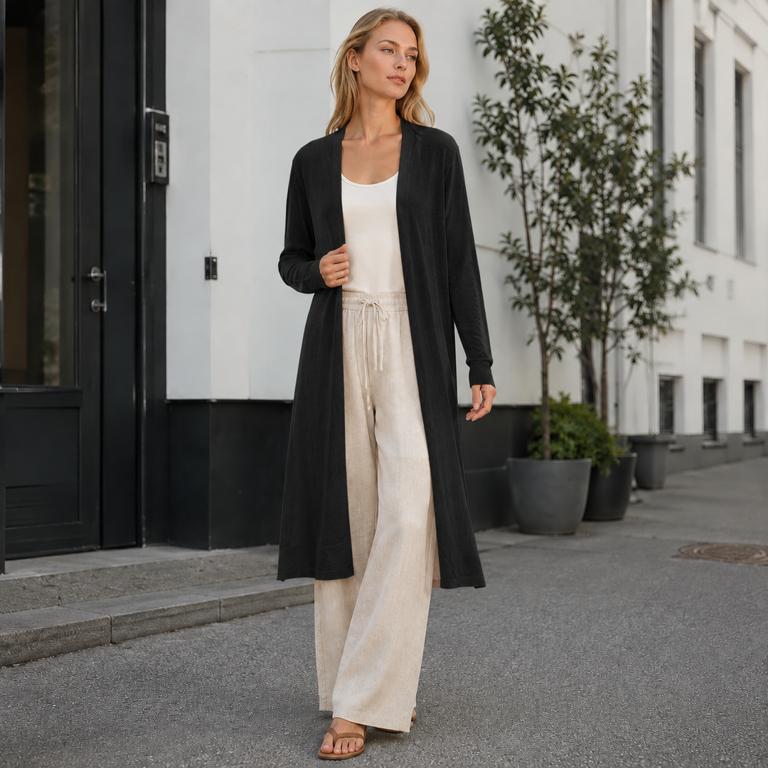 Woman modeling a cozy long warm cardigan, layered over a shirt. Ideal fall & winter outerwear style.