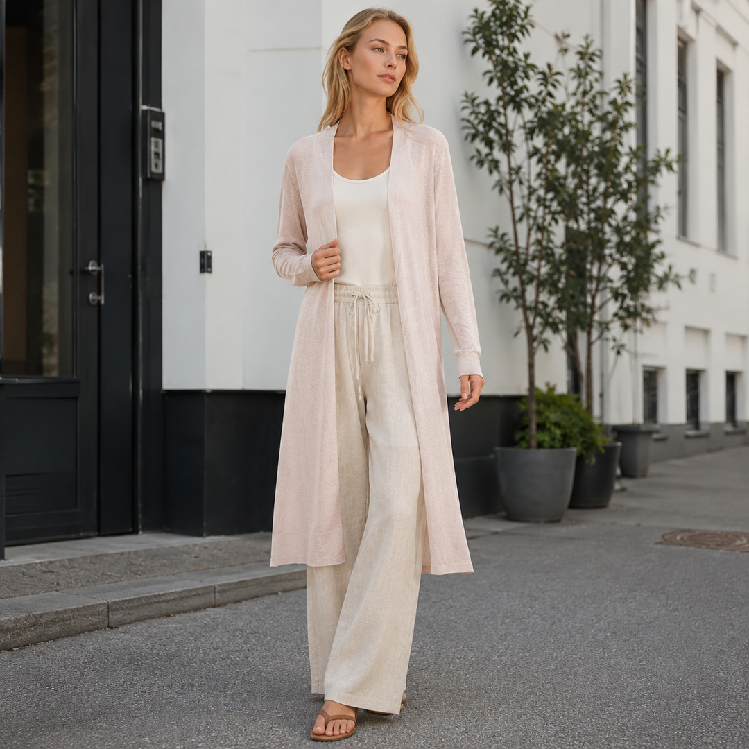 Detail of a women's long warm knit cardigan, showcasing its soft texture. Perfect for versatile layering.