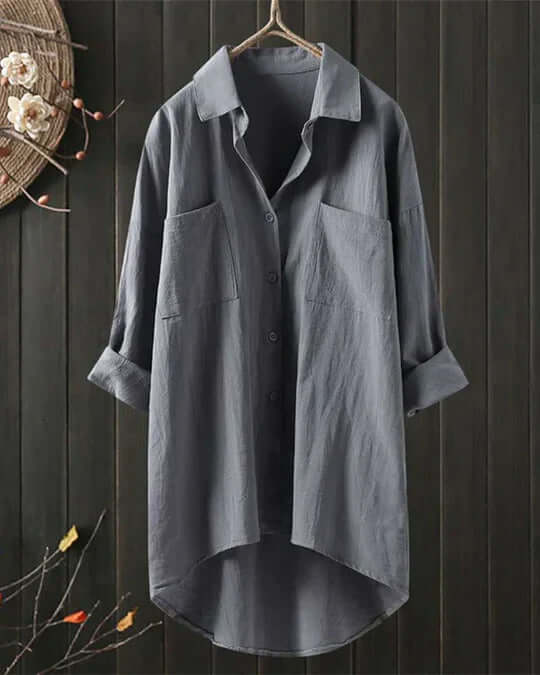 Comfortable women's collared casual blouse. Features roll-tab sleeves & two chest pockets for relaxed summer fashion.