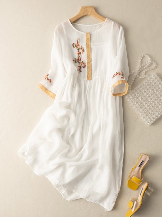 Comfortable women's loose fit boho midi dress with round neck and intricate embroidery detail.
