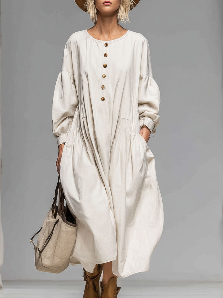 Women's loose fit midi dress with button-front closure and practical side pockets, perfect for casual everyday wear.