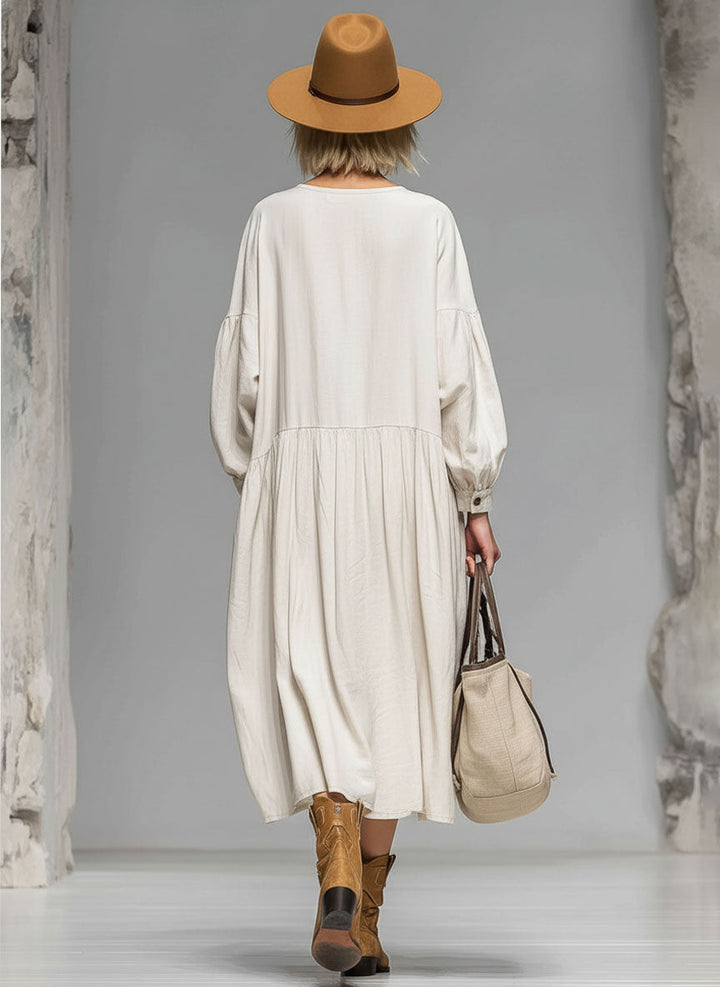 Versatile women's loose midi dress with full button front, long sleeves, and practical pockets for everyday comfort.