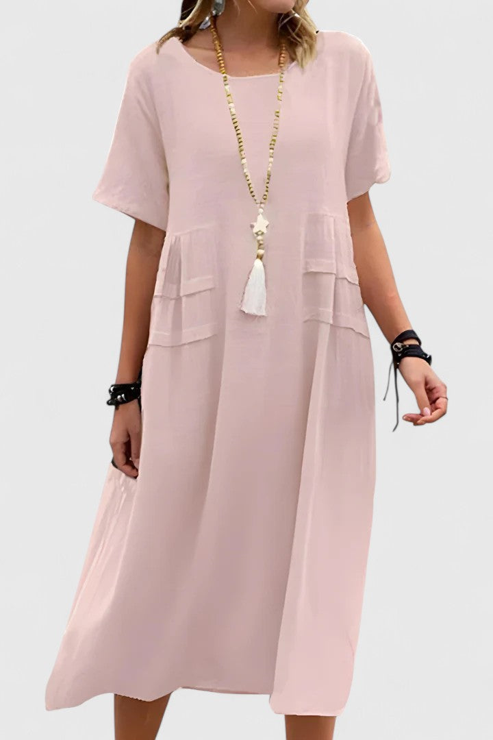 Stylish women's loose fit midi dress with short sleeves and pockets, offering relaxed everyday comfort.