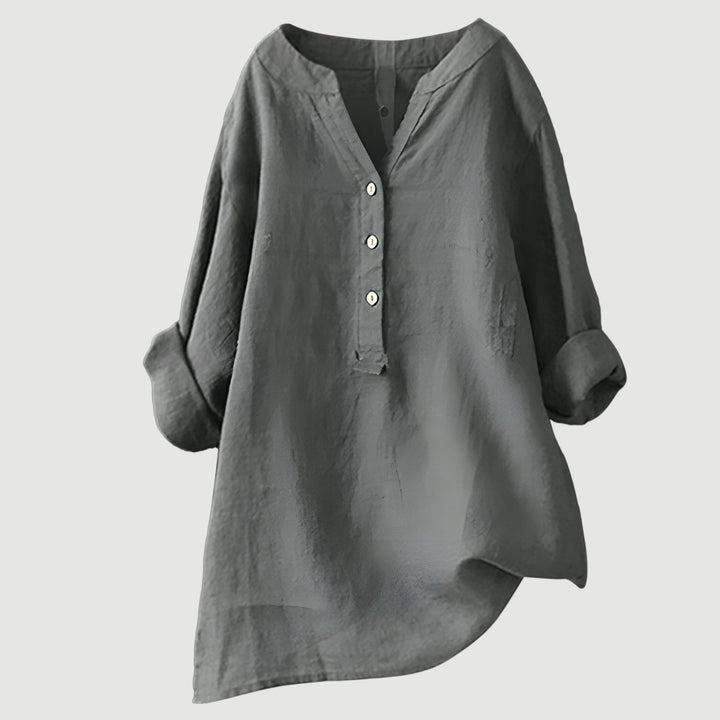 Versatile women's button-up blouse, loose fit v-neck, and rolled sleeves. Great for casual or elegant styles.