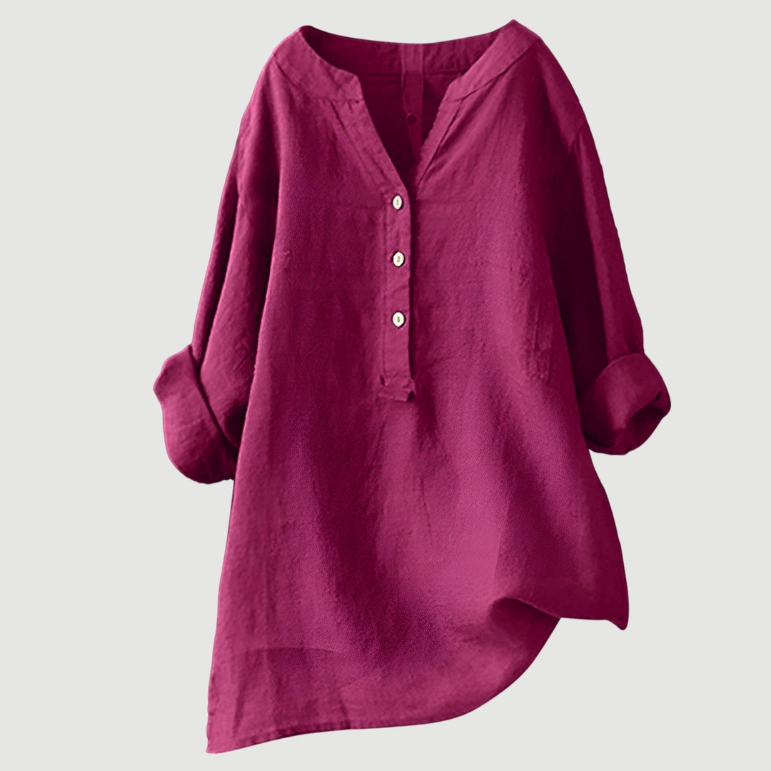 Comfortable loose fit women's blouse featuring a v-neck and rolled sleeves. Effortless elegant spring/summer top.