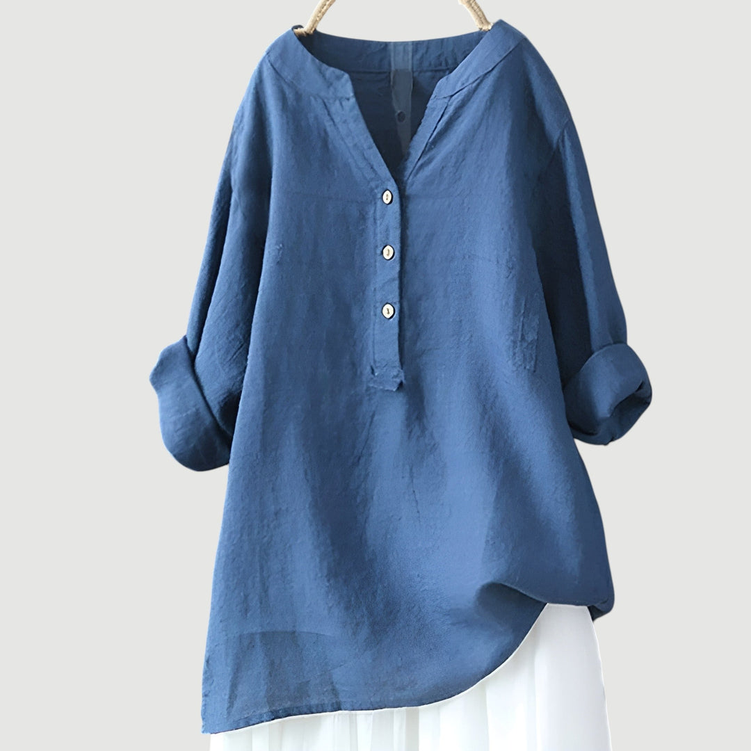 Women's loose fit blouse. V-neck, rolled sleeves, and button-up design. A versatile and stylish top.