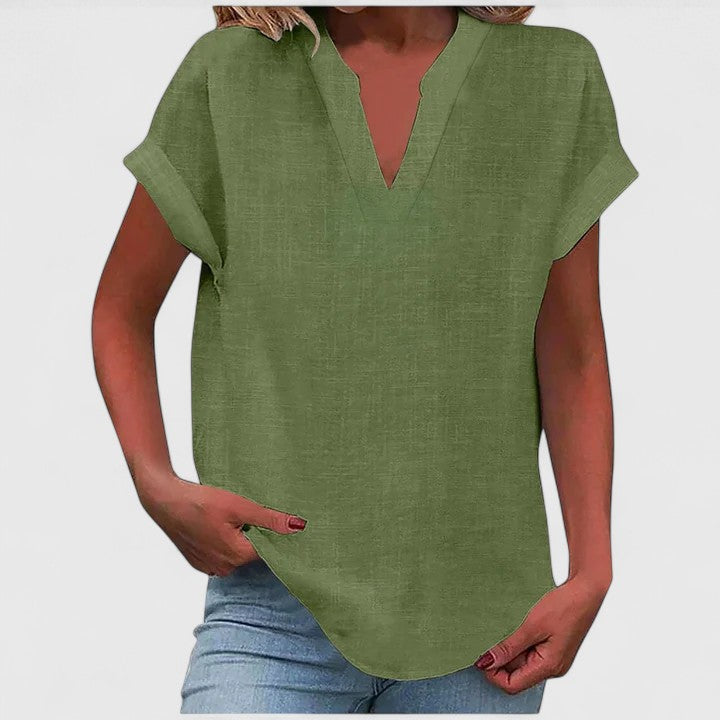 Model wears relaxed loose fit V-neck casual blouse with cap sleeves, comfortable chic style.