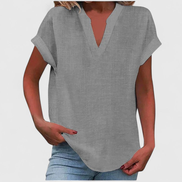 Close-up of V-neck casual blouse, highlighting loose fit & soft fabric, perfect for everyday wear.