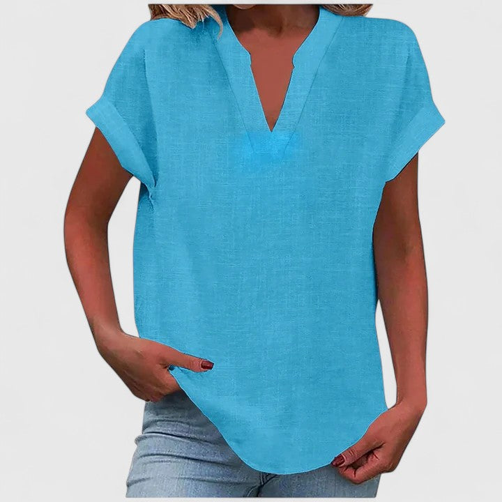 Back view of women's loose fit V-neck blouse, showing relaxed silhouette & curved hem.
