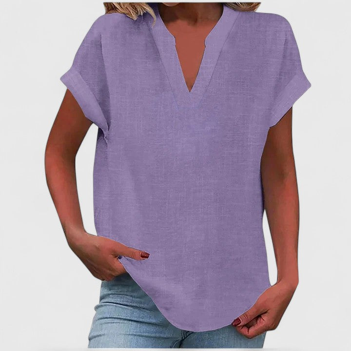 Side view of casual V-neck women's blouse, featuring loose fit & cap sleeves, versatile style.