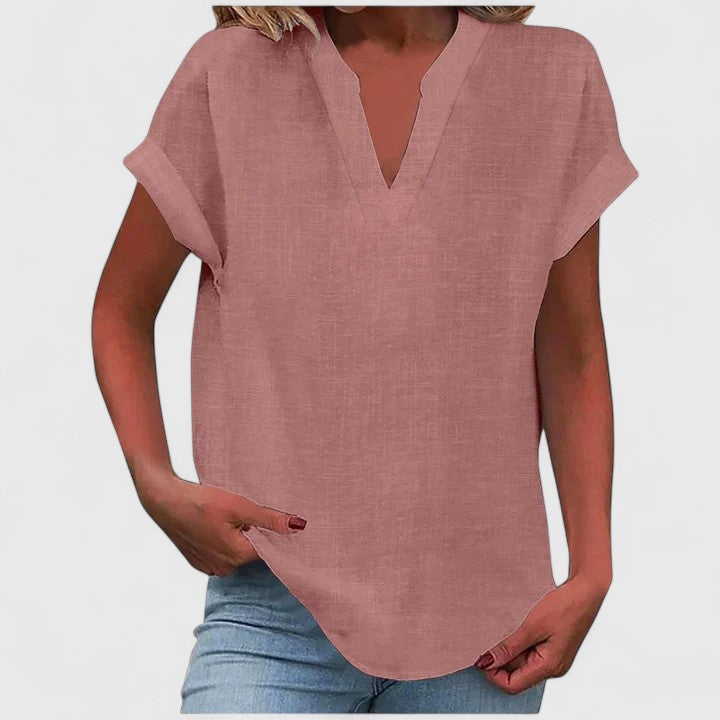 Women's loose fit V-neck blouse styled with jeans, a chic and comfortable casual outfit.