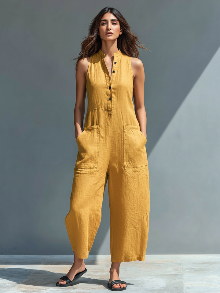 Relaxed fit women's button-up jumpsuit. Sleeveless design, stand collar for a chic spring/summer look.