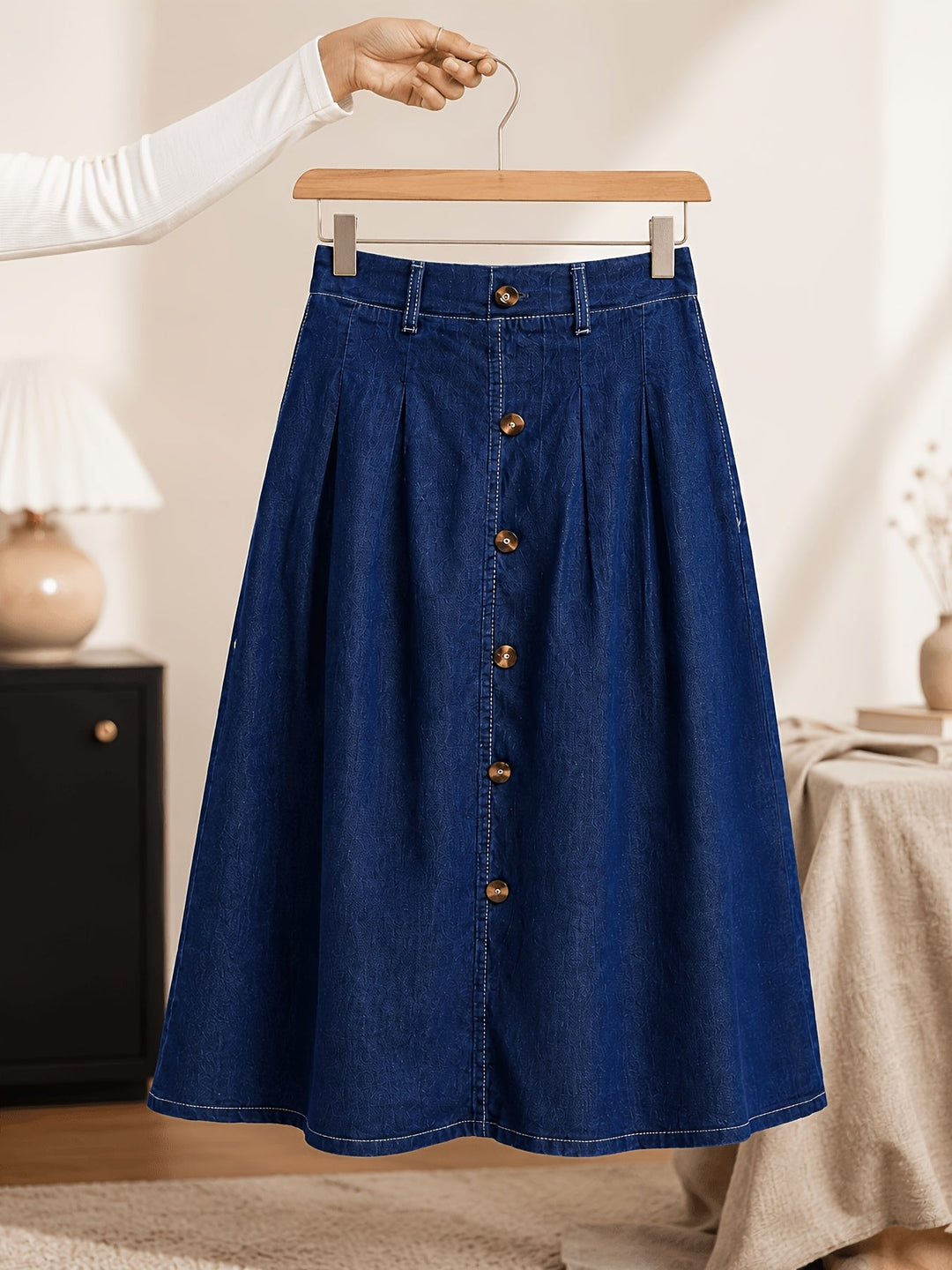 Pleated A-line midi skirt for women in medium blue. Features a stylish button front, ideal for spring & summer.