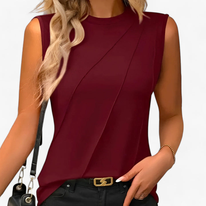 Chic women's sleeveless top, a draped mock neck blouse offering an elegant and versatile look for any occasion.