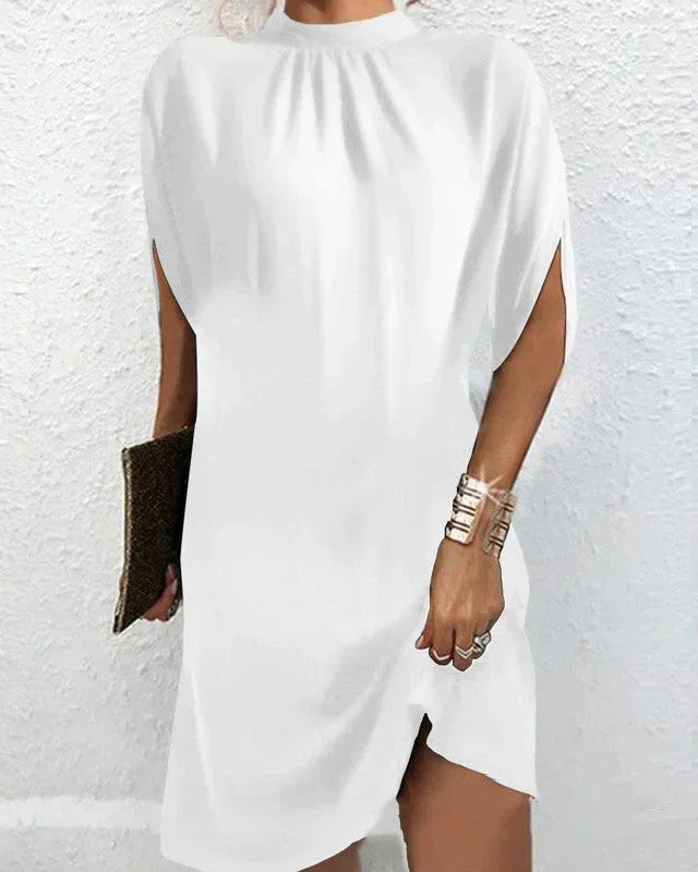 Elegant women's cocktail mini dress featuring a sophisticated mock neck and dramatic cape sleeves.