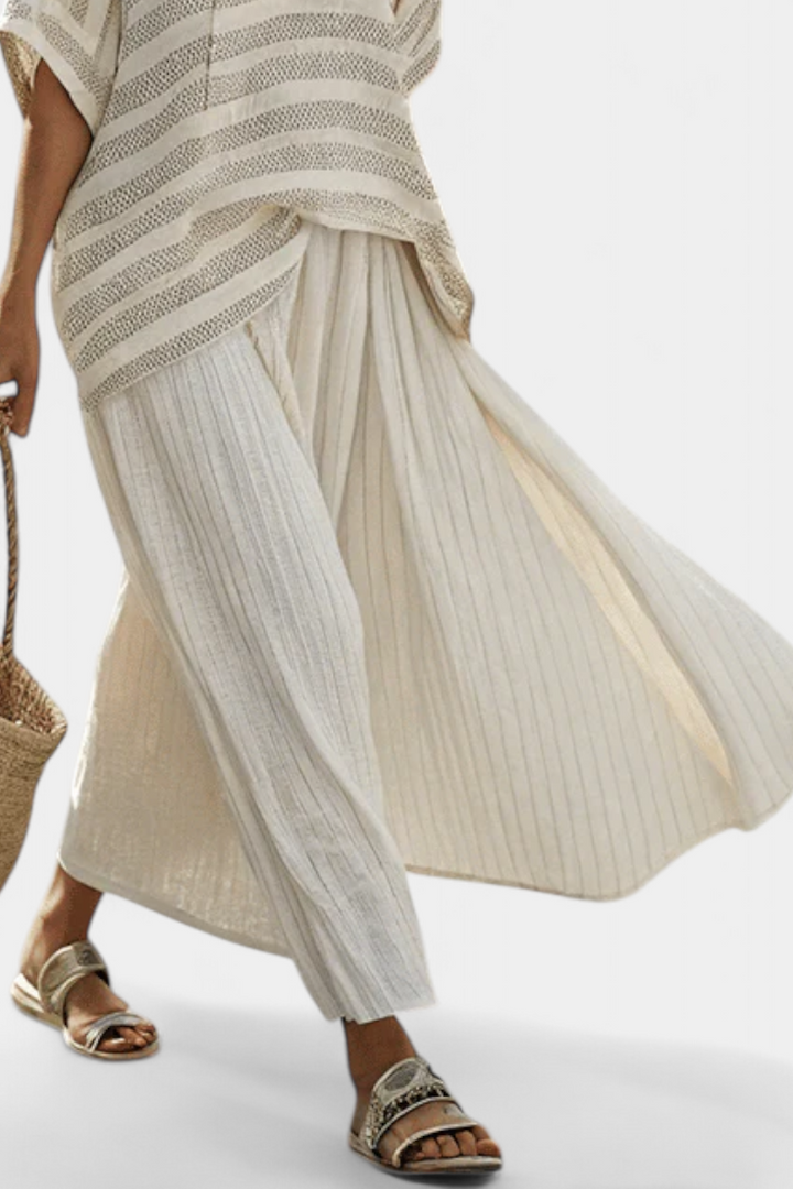 Stylish women's two-piece set featuring a relaxed batwing top with multi-color stripes and a comfortable flowy maxi skirt.