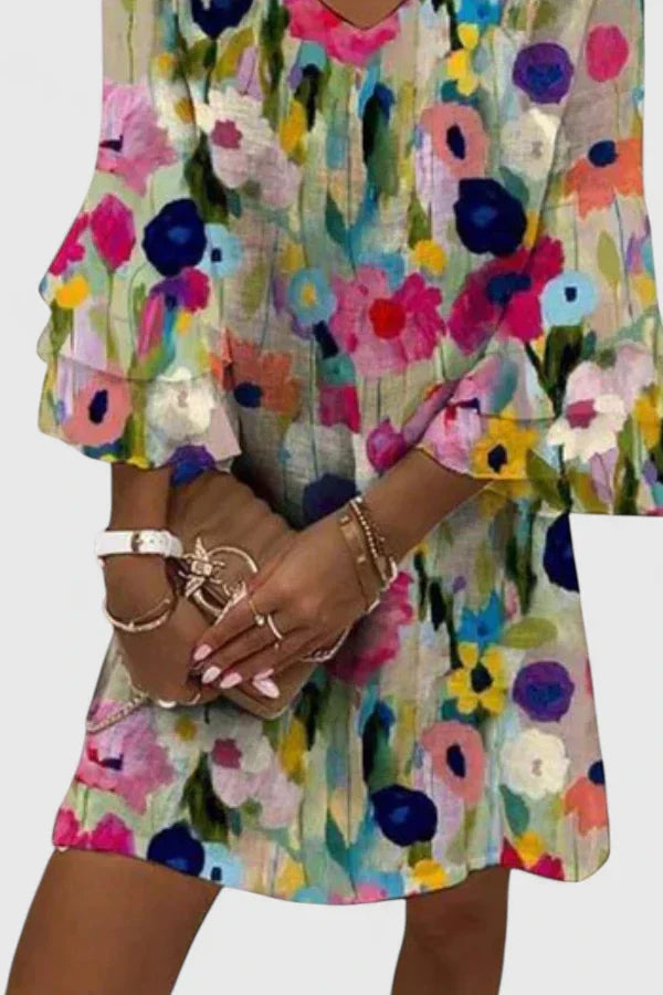 Versatile women's floral print mini dress. Features a comfy v-neck and short ruffled sleeves for warm weather.