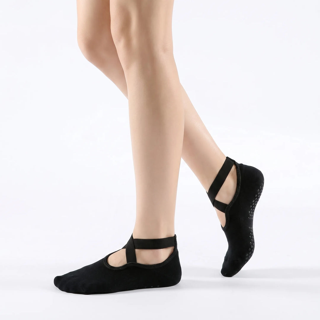 Close-up of women's non-slip yoga socks, showcasing textured soles for enhanced traction during studio fitness & pilates.