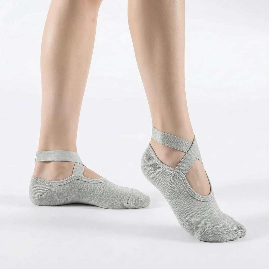 Pair of women's non-slip textured yoga socks, folded. Essential athletic socks for studio workouts, pilates, and ballet.