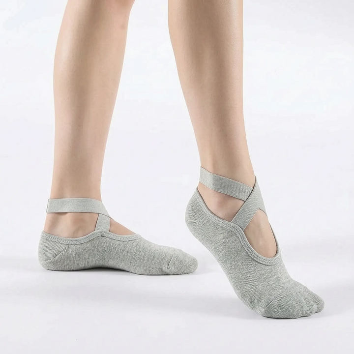 Pair of women's non-slip textured yoga socks, folded. Essential athletic socks for studio workouts, pilates, and ballet.