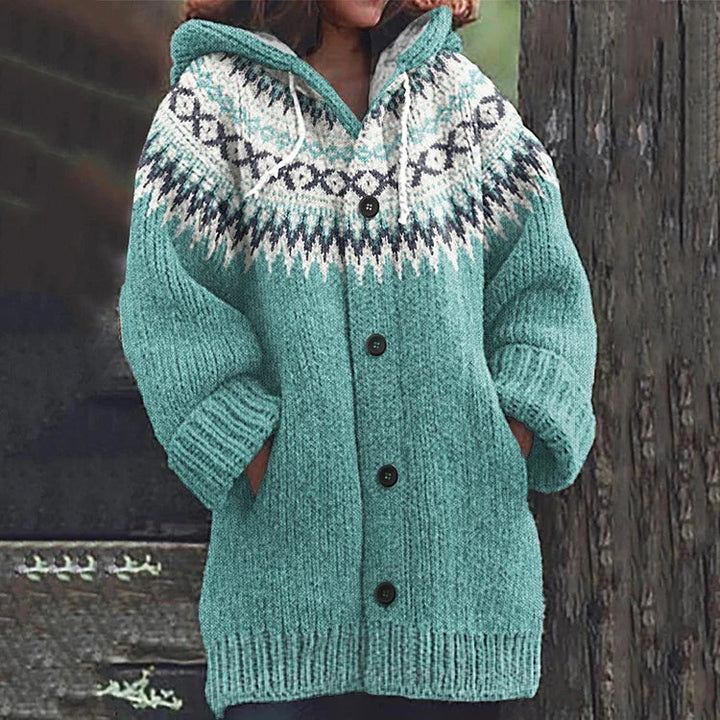 Woman wearing a warm, long sleeve Nordic hooded knit cardigan, showcasing its comfortable relaxed fit.