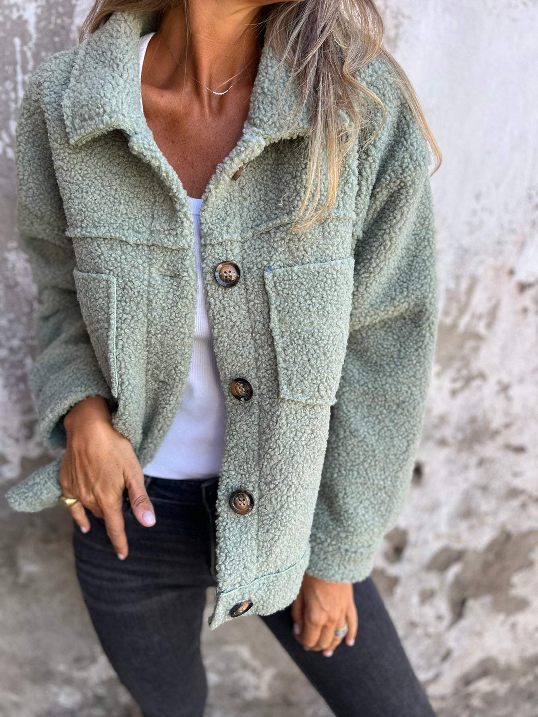 Front view of a women's sophisticated button-up notch collar autumn coat, essential fall outerwear.
